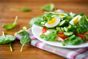 Salat mit Blattspinat, Gurke, Tomaten und Eiern